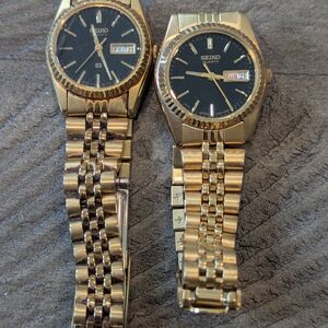 Two Seiko Gold Watches with Black Dials